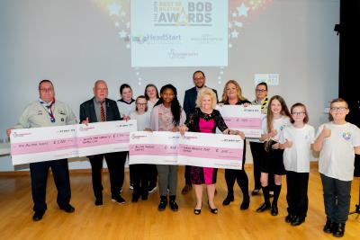 Some of the winners of Bilston’s Dragons’ Den are awarded their cheques by John Goodman, The National Lottery Community Fund Midland Funding Officer (back, centre) and HeadStart’s mini ambassadors