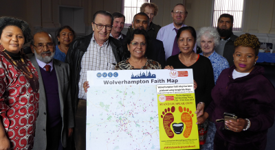 Members of Interfaith Wolverhampton proudly holding a physical representation of the Wolverhampton Faith Map