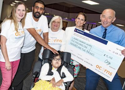 Tim Johnson, Managing Director at City of Wolverhampton Council pictured with Livvy from Acorns Children’s Hospice, Amjid Mehmood with his daughter Zara and his transport colleagues Amanda Millard and Linda Downing