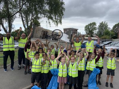 Pupils from Trinity Church of England Primary School with team members from the council’s Environmental Services and Public Protection team. (Elliott, standing on the far right)