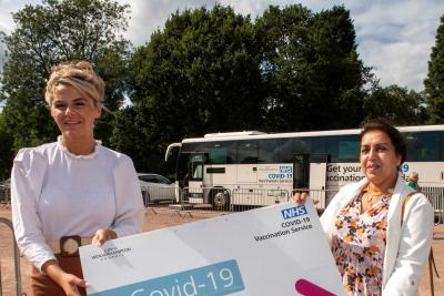 (l-r): Councillor Beverley Momenabadi, Cabinet Member for Children and Young People, with Councillor Jasbir Jaspal, Cabinet Member for Public Health and Wellbeing, with the vaccine bus in Phoenix Park