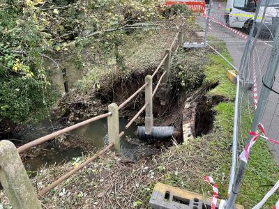 Image showing the collapsed section of embankment and water coming close to the pavement on Bridgnorth Road