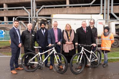 (L-R): In front of the new Cycle Hub site at Wolverhampton Interchange are Chris Jones, ION Associate Development Director, David Hibbs, Cycle Rail Manager at Sustrans, Subeagh Singh, SLC Rail Senior Project Manager, Malcolm Holmes, Executive Director at West Midlands Rail Executive, Mel Bryett, Wolverhampton station manager for West Midlands Railway, Cllr Stephen Simkins, City of Wolverhampton Council Deputy Leader and Cabinet Member for City Economy, Tim Philpot, City of Wolverhampton Council Professional Lead – Transport Strategy, and Lindsay Jones, Project Coordinator for contractors Marshdale