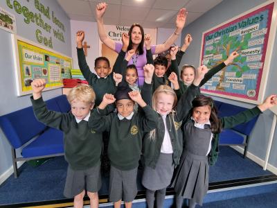Christ Church CE Infant and Nursery pupils join Executive Headteacher Sarah Blower to celebrate their school's continuing success