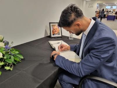 Conservative Councillor for Tettenhall Regis Udey Singh signs the book of condolence to remember Councillor Ian Brookfield