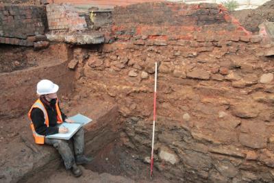 Archaeologist Abbie Horton recording Old Hall’s extended curtain wall, which ran inside the moat