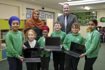 (L-R): Front row – Pupils Sehbaaz Singh, 9, Olivia Darrell, 7, Gurjivan Kaur, 7, Cody-Lee Burden, 8, Teddie-John Cole, 7, and Erika Kaur, 9. Back row - Councillor Obaida Ahmed, City of Wolverhampton Council Cabinet Member for Digital and Community Inclusion, and Jonathan Webb, Deputy Headteacher at Long Knowle Primary School