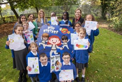 Staff and pupils at Dovecotes Primary School celebrate the arrival of the Bug Busters with some of the posters they designed to raise awareness of the ways people can protect themselves from winter illnesses