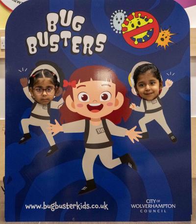 Pupils at Stowlawn Primary School pose with one of the Bug Busters heroes