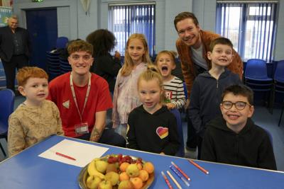 Councillor Chris Burden, Cabinet Member for Children and Young People, with children enjoying making smoothies as part of the Yo! Wolves October half term activities at UK S Futures autumn holiday camp