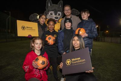 Councillor Jasbir Jaspal, Cabinet Member for Adults and Wellbeing, Councillor Christopher Burden, Cabinet Member for Children and Young People, Wolves Foundation Community and Cohesion Officer Nikki Lal and young people celebrate the launch of the new Yo! Active programme