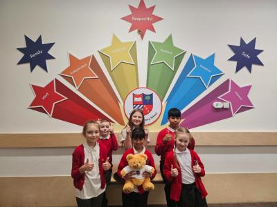 Stowlawn Primary School Language Ambassadors celebrate their Inclusion Quality Mark award with Dexter, the IQM bear