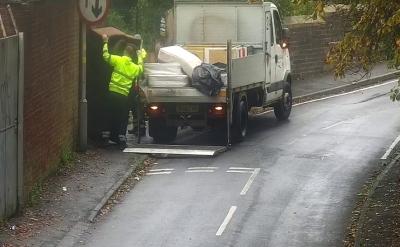 Members of the council’s environmental crime team removing a sofa that was dumped in Bilston