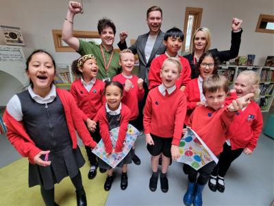 Left to right, back, Teacher Ryan Pitt-Woodcock, Councillor Chris Burden, Cabinet Member for Education, Skills and Work, and Sarah Green, Assistant Headteacher, celebrate with pupils after Stowlawn Primary School was awarded the Excellence in Pupil Development award