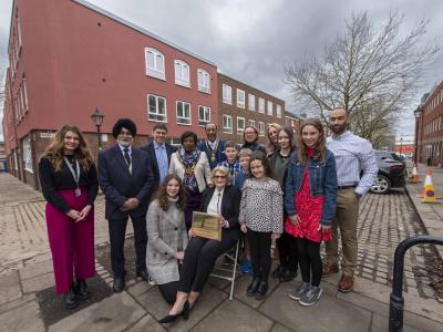 Peter’s widow, Nicky, holding the naming plaque surrounded by Peter’s son James and wife Audrey, daughter Emma and husband Chris, along with Peter's six grandchildren and from the left, Rebecca Harrington-Leigh, Director of Services at P3, Cllr Bhupinder Gakhal and Mayor of Wolverhampton, Cllr Sandra Samuels OBE, and her consort Karl Samuels, outside Peter Bilson House