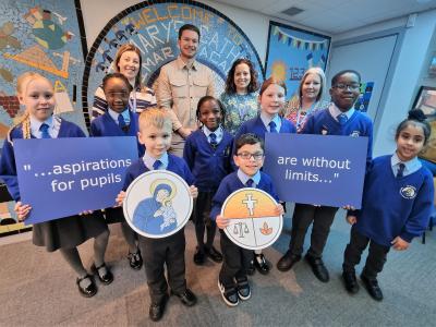 Pupils from St Mary’s Catholic Primary Academy celebrate their Good Ofsted rating with Kerry Cox, Vice Principal, Councillor Chris Burden, Cabinet Member for Education, Skills and Work, Vicky Minihane, Principal, and Sarah Smith, Vice Principal