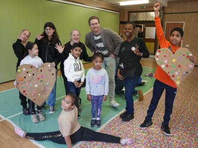 Left to right in the centre, Jenny Smith, Creative Director at Curiosity Productions, Councillor Chris Burden, Cabinet Member for Children and Young People, and Claire Okeke, Creative Assistant at Curiosity Productions, with children attending the Curiosity Club during February half term