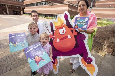 Fynn Flanagan, who created Wheezy and Sneezy, the Flu Twins, and his sister Ayla, who helped inspire Lord Fever, with the City of Wolverhampton Council's Cabinet Member for Public Health and Wellbeing Councillor Jasbir Jaspal and Wolverhampton's Director of Public Health, John Denley