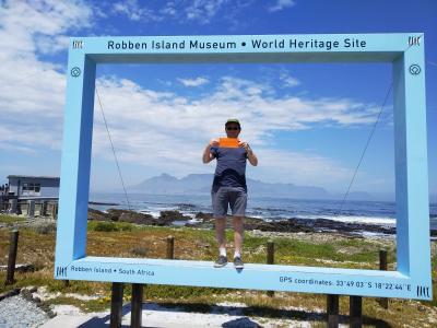 Steve Dodd, Chair of Wolverhampton Safeguarding Together Community Engagement Sub-group, took the #OrangeWolves message to Robben Island, with Table Mountain and Cape Town in the background