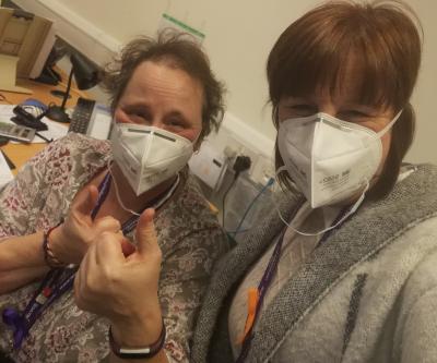 Council workers Tina Wooley and Suzanne Cash with 2 of the masks donated by Fosun