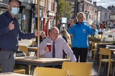 Cabinet Member for City Environment, Cllr Steve Evans, enjoys a drink on the new seating outside The George Wallis with General Manager designate Stonegate Pubs, Adam Davis, and Wolverhampton BID Ambassador, Jo Parker
