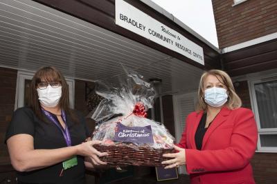 Councillor Linda Leach, cabinet member for adult services, presents a donated hamper to Pam Fellows, manager of Bradley Resource Centre, Bilston