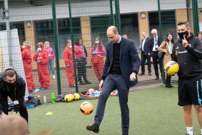 Prince William playing football with the youngsters