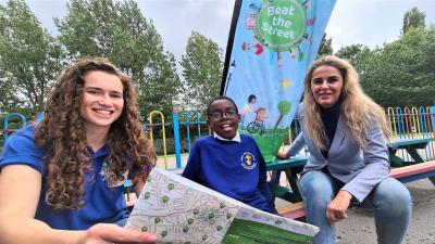 Left to right, Lottie Bozon, Beat the Street Engagement Coordinator, Bilston C of E Primary School pupil Joshua Vassell-Oluwu and Councillor Beverley Momenabadi, Cabinet Member for Children and Young People, browse the Beat the Street map showing where over 200 Beat Boxes will be located
