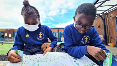 Rennayah Morris and Joshua Vassell-Oluwu, pupils at Bilston C of E Primary School, look at Beat Box locations on the map as they prepare for the start of Beat the Street next week