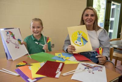 Councillor Beverley Momenabadi, the City of Wolverhampton Council's Cabinet Member for Education and Skills, and Heidi Gottscall, aged 10, with their crafty creations