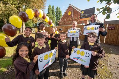 Pupils at Holy Rosary Catholic Primary Academy celebrate its Good Ofsted rating with, centre back, Councillor Dr Michael Hardacre, the City of Wolverhampton Council's Cabinet Member for Education and Skills, and Principal Adam Jewkes