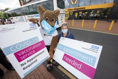Mascot Wolfie and Daini Flowers, Clinical Lead with the vaccine bus when it visited Molineux Stadium recently
