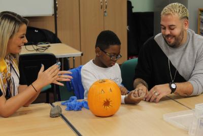 Councillor Beverley Momenabadi, the City of Wolverhampton Council's Cabinet Member for Children and Young People, joins a pumpkin carving and clay making session at Wildside Activity Centre