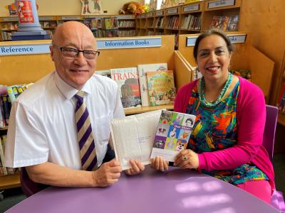 Councillor Jasbir Jaspal, Cabinet Member for Public Health and Wellbeing, with a copy of Dear Ma'am, which was sent to Her Majesty The Queen this week, and Chief Librarian Robert Johnson