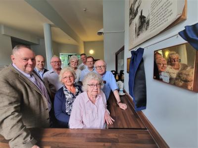 At the unveiling of Tom Larkin’s memorial plaque are: BACK (L-R): Luke Dove, Head of Assets at City of Wolverhampton Council; Howard Lloyd, husband of Tom’s niece Miriam; Joan Tranter, family friend; Simon Archer, Discover Bilston and family friend; Bernard Tonks, Tom’s cousin. FRONT (L-R): Councillor Stephen Simkins, Deputy Leader of the Council and councillor for Bilston East; Miriam Lloyd, Tom’s niece; Emily Larkin, Tom’s wife; Hugh Larkin, Tom’s son