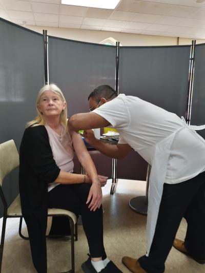 A visitor receives her vaccination at the pop-up clinic at the Bilal Mosque from Central Health’s Abul Kashem