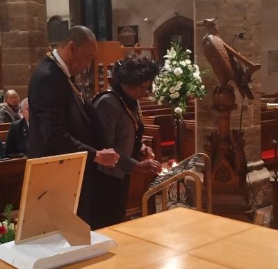 The Mayor of Wolverhampton Councillor Sandra Samuels OBE lights a candle at St Peter's Collegiate Church during the National Moment of Reflection