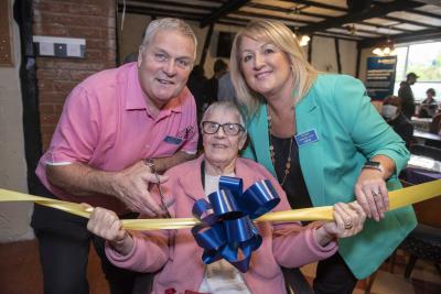 Memory Café member Margaret Nash, aged 84, is joined by Stuart Richmond, President of Bilston and Willenhall Lions Club, and Councillor Linda Leach, the City of Wolverhampton Council's Cabinet Member for Adult Services, to officially open the Bilston Memory Café