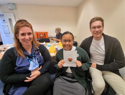 Katie Smith, Immunisation Nurse at Vaccination UK, and Councillor Chris Burden, Cabinet Member for Education, Skills and Work, with a pupil receiving their flu vaccination, delivered via a painless nasal spray