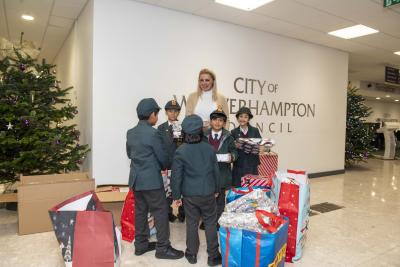 Councillor Beverley Momenabadi accepts the donation from the adopted brothers and their friends on behalf of the City of Wolverhampton Council. The gifts have been donated to Graiseley Strengthening Families Hub for distribution to children in need in Wolverhampton this Christmas