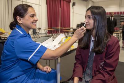 Anika Sharma, a Year 9 Thomas Telford UTC student, receives her flu vaccination from Immunisation Nurse Sangeet Wyllie