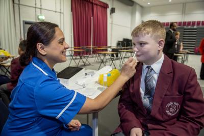 Year 8 student Logan Clarke is vaccinated by Immunisation Nurse Sangeet Wyllie