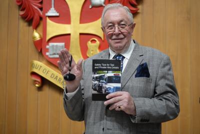 Councillor Phil Page, chair of City of Wolverhampton Council’s statutory licensing committee and regulatory committee, with a personal safety alarm and copy of the taxi drivers’ safety guide