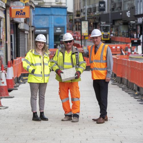 (L-R): Megan Bloxham, Eurovia Public Liaison Officer, Michael Gough, Eurovia Ground Worker, and Councillor Steve Evans, City of Wolverhampton Council Cabinet Member for City Environment and Climate Change on Victoria Street as the first new paving goes down